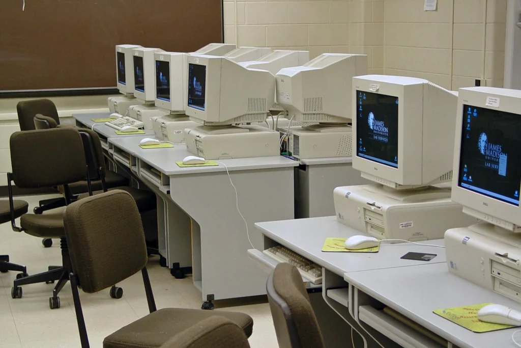 Old desktop computers in classroom.