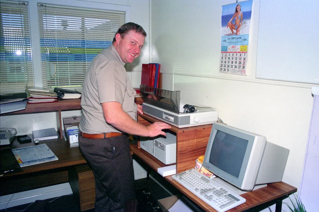 Man operating dot matrix printer.