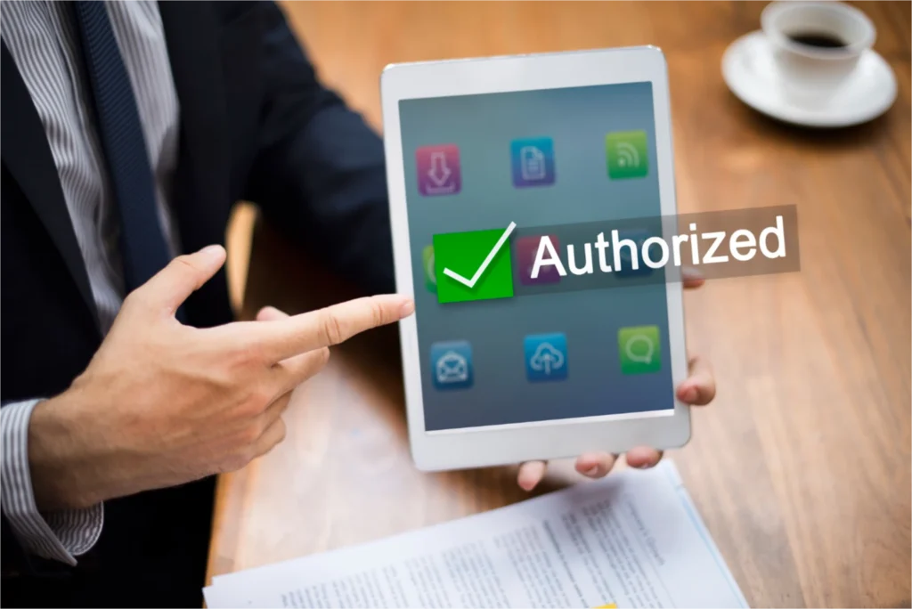 Person holding tablet showing 'Authorized.