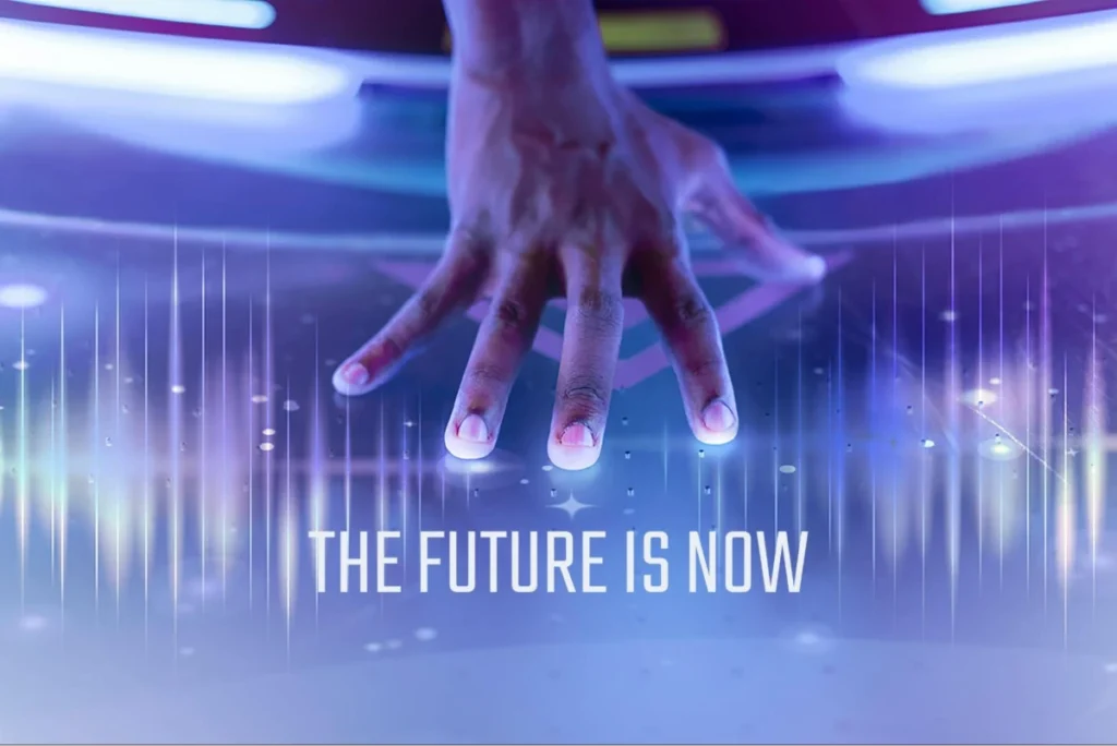 Hand on futuristic interface with 'The Future is Now' text