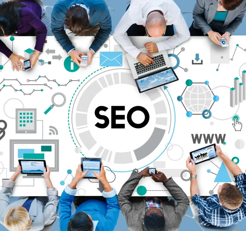 A group of professionals working together on SEO strategies with various devices and digital tools.