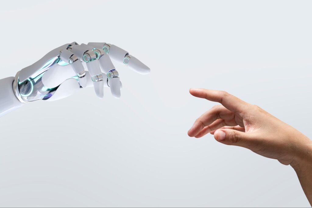 Human hand reaching towards robotic hand.