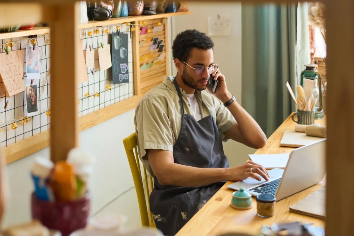 Ceramic artist working on laptop